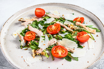 Fresh Chicken salad with feta, tomato, nuts and vegetables. healthy food concept. gray background. Top view.