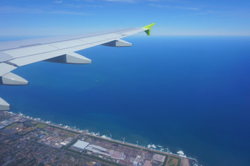 Fototapeta premium Approach Narita Airport. Air travel. Blue sea under the airplane wing