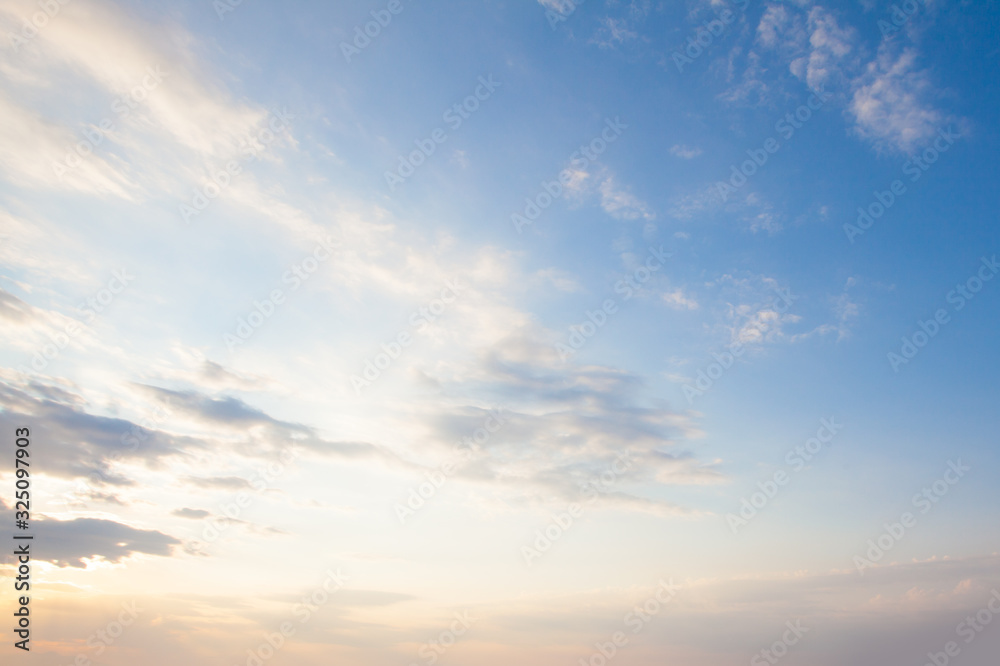 Wall mural blue sky clouds background. beautiful landscape with clouds and orange sun on sky