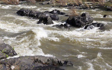 River and rocks with visible movement of the water, landscape view. Suitable for wallpaper