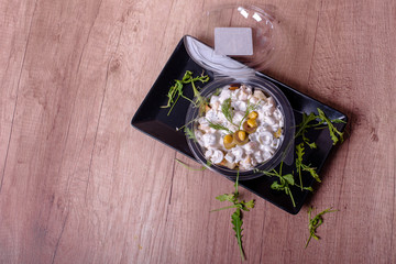 Obraz na płótnie Canvas Creamy salad in a plastic bowl served on a plate