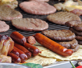 Beef burger and sausages on the grill