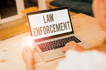 Conceptual hand writing showing Law Enforcement. Concept meaning activity of making certain that...
