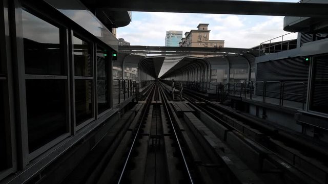 4k, Point of view of automatic train moving through Taipei tunnels via guideway transit system. Metro moving forward crossing capital city. Asia tourism, transport technology concept-Dan