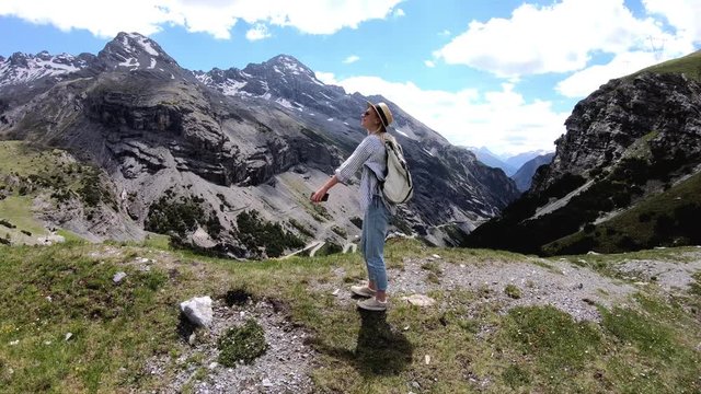 Excited adventurous hipster girl wanderlust feeling freedom on top in alps on summer vacation, Happy overjoyed millennial female tourist turning around feeling carefree during travel to Mountain