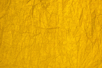 Texture of bright wrinkled yellow paper for background.