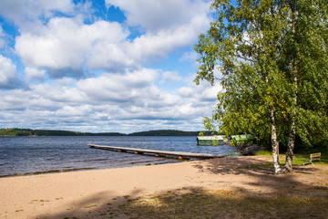 View to The Lake Saimaa and wooden swimming pier from Lempukka Beach, Imatra, Finland