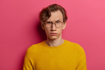 Are you serious? Strict indignant man raises eyebrows, has some doubts, being not sure, focused at...