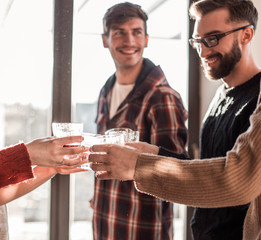 background image of a glass of juice in the hands of the young couple