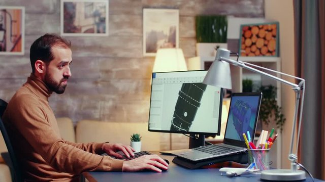 Young engineer working late at night in his home office