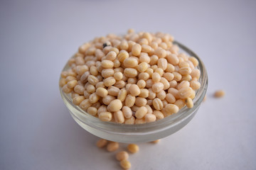 Peeled Black Gram Dal/Black Beluga Lentils in A Glass Bowl on White Background Close-Up Stock Photograph Image