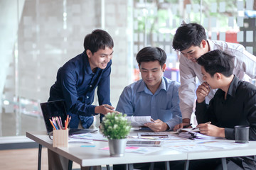 Groups of young man who talking together to discuss the work in the workplace.