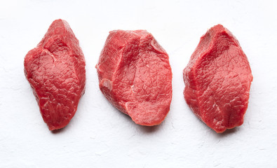 Raw filet mignon on white stone backgroundbackground