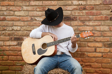 Happy Cowboy sitting with a guitar