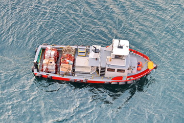 Loading of supplies and provisions from the boat to the ship on the roadstead.