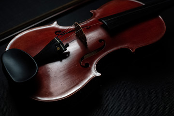 The wooden violin put on background,show front side of acoustic instrument