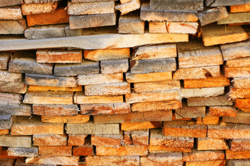 Wooden boards, lumber, industrial wood. Industrial timber. Wood background. Pile of planks. Warehouse wood storage for sawing boards.