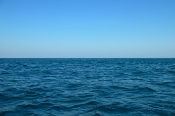Fototapeta na wymiar Beautiful blue sea on sky background