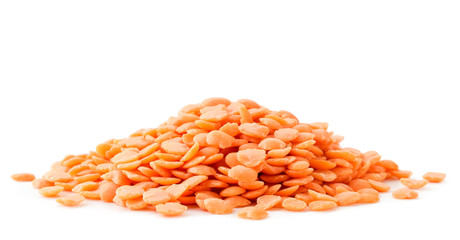 Pile of red lentils in close-up on a white background. Isolated
