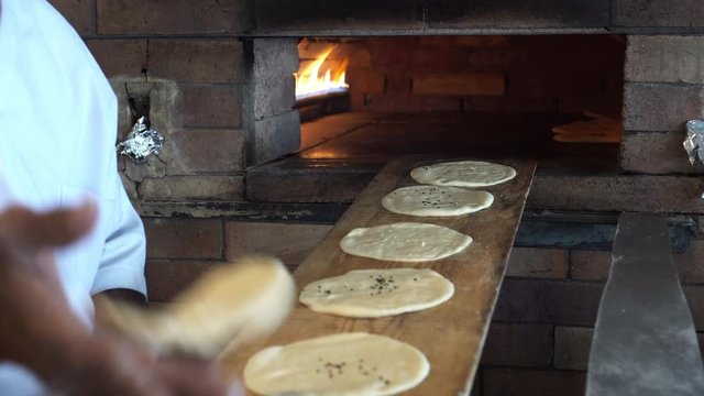 Arabian African aish bread fesh baking in brick oven