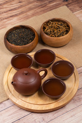 Asian tea with clay tea set and two wooden bowls