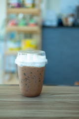 Iced coffee mocha with foam milk in plastic glass