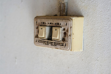  Old power switch for lamp, Old light switch without cover on the white cement wall.