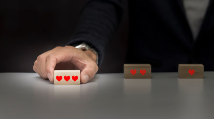 Business man giving rating with three red heart icon for  concept