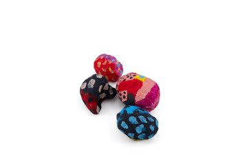 Round hand-crafted papier mache objects, painted in different colors and abstract patterns on a white background. Representing the creative process and creativity. Possible backdrop for presentations.