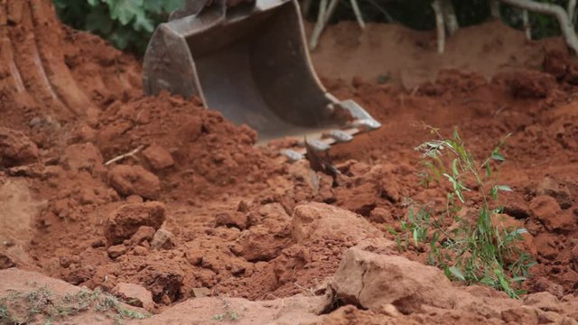 Close up of JCB Bulldozer shovel digging soil