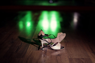 Pair of dancing shoes on the dance floor under the spotlights