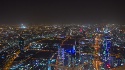 Fototapeta na wymiar Skyline with Skyscrapers night timelapse in Kuwait City downtown illuminated at dusk. Kuwait City, Middle East