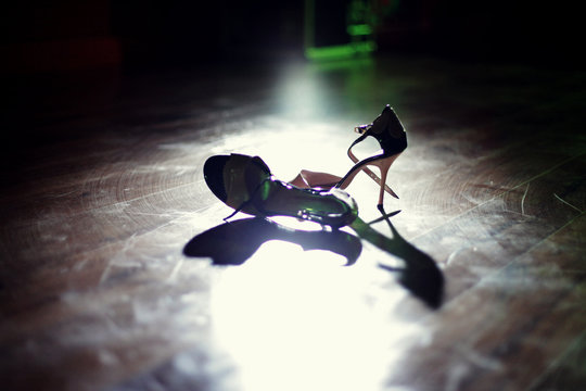 Pair of dancing shoes on the dance floor under the spotlights