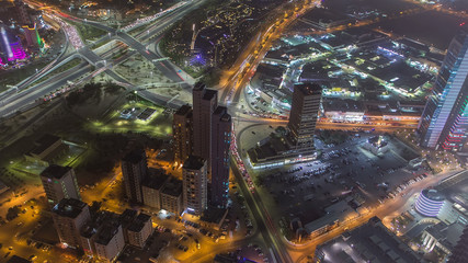 Skyline with Skyscrapers night timelapse in Kuwait City downtown illuminated at dusk. Kuwait City, Middle East