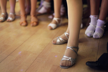 Children's legs in a ballroom dancing shoes ready to dance competition - obrazy, fototapety, plakaty