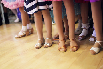 Children's legs in a ballroom dancing shoes ready to dance competition