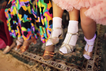 Children's legs in a ballroom dancing shoes ready to dance competition