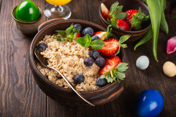 Homemade oatmeal granola or muesli with fresh berries for healthy easter morning breakfast, selective focus. Healthy food background, copy space.