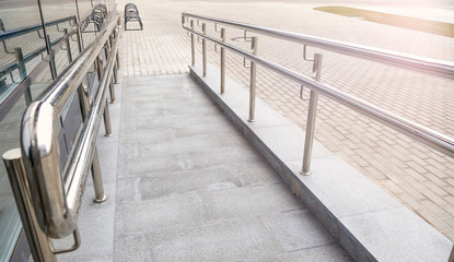 Ramp way with stainless steel handrail for support wheelchair disabled people infront of the...