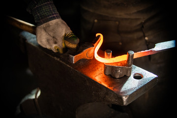 A man blacksmith making a unique handle for the knife - obrazy, fototapety, plakaty