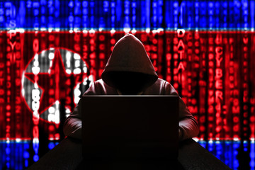Cyber threat from North Korea. North Korean hacker at the computer, on a background of binary code,...