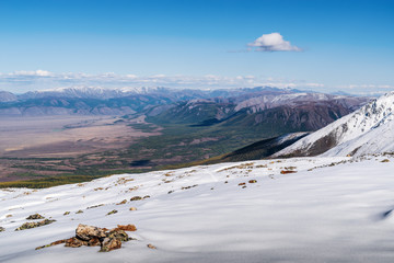 Fototapeta na wymiar Mountain landscape, view from a snowy mountain peak. Uchitel pass, Severo-Chuysky ridge, Altai Republic, Russia