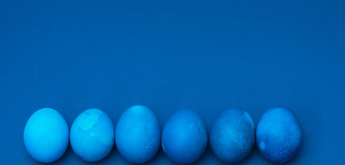 classic blue easter eggs on blue background. monochromatic composition. place for text