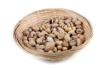 Salted pistachio nuts in wicked plate