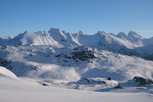 Picture taken on a path to Kvalvika beach. Beautiful winter scenery with an unique mountains. Very popular area for outdoor activities as hiking, skiing, ski-touring. Soft late afternoon light.