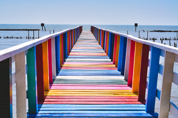 Colorful wooden bridges stretching from the coast down to the sea.