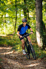 Fototapeta na wymiar Young sporty man practicing mountain biking