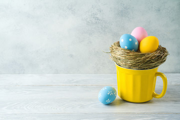 Easter holiday decorations with easter eggs on wooden table