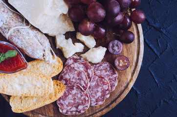 Wooden board full of mediterranean appetizers