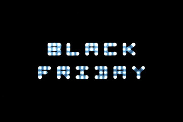LED lights with the word Black Friday on black scoreboard background
